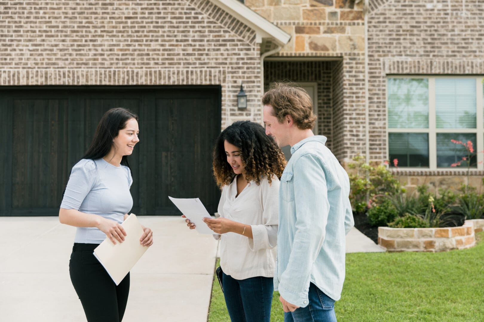 Couple reviewing house documents with agent