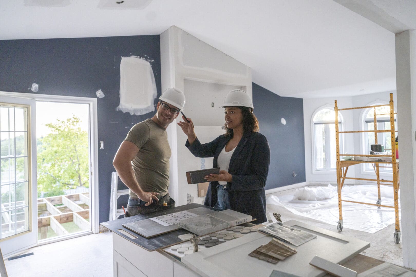 Two people in hard hats at construction site