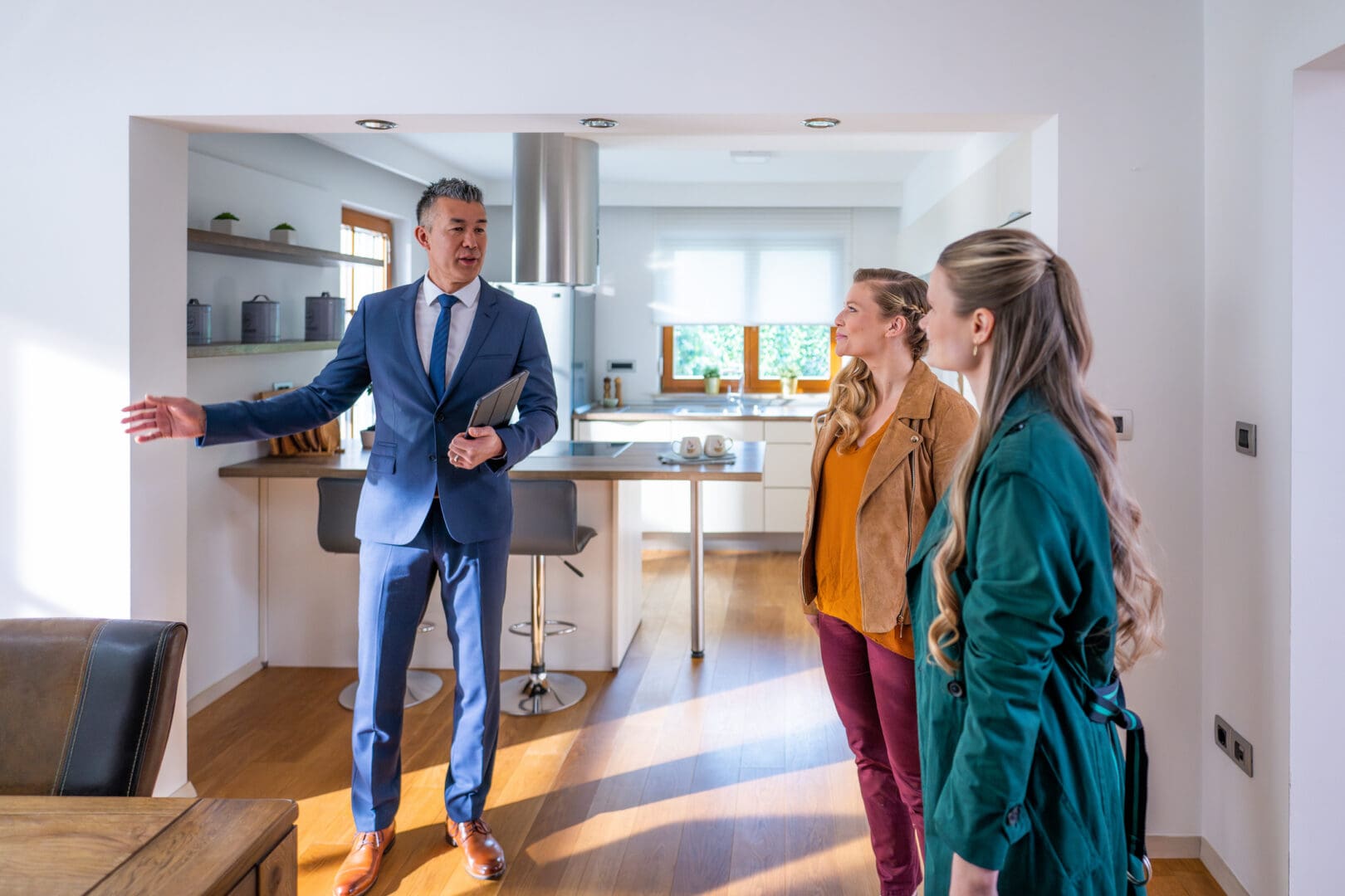 People viewing a bright, spacious kitchen