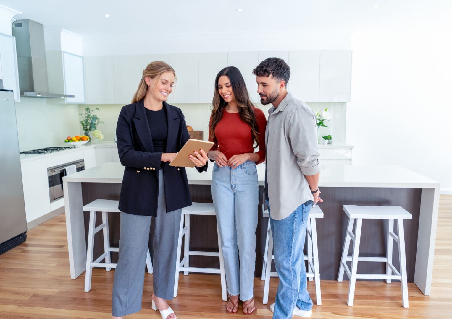 Couple viewing modern kitchen with agent