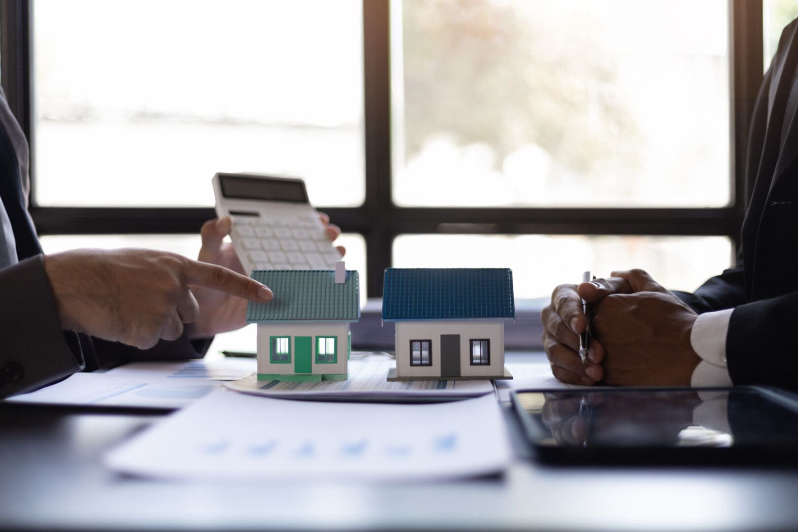 Real estate discussion with house models.