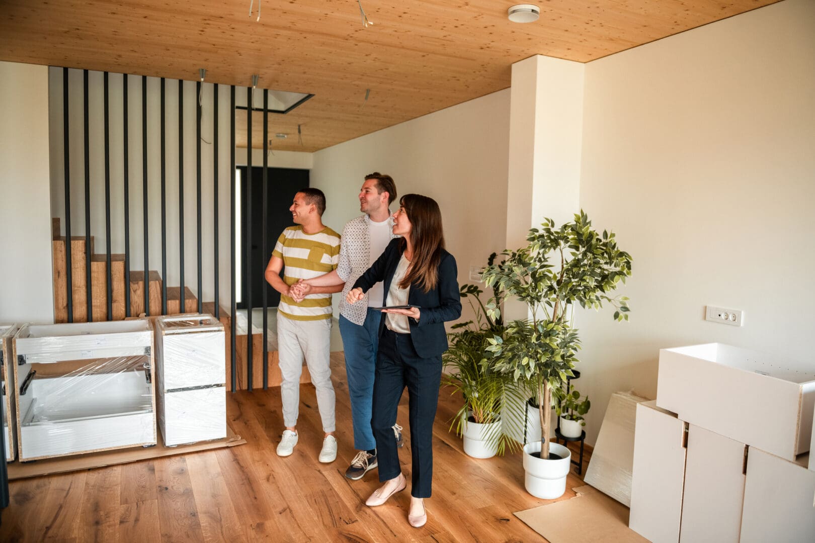 People touring a modern, unfurnished apartment