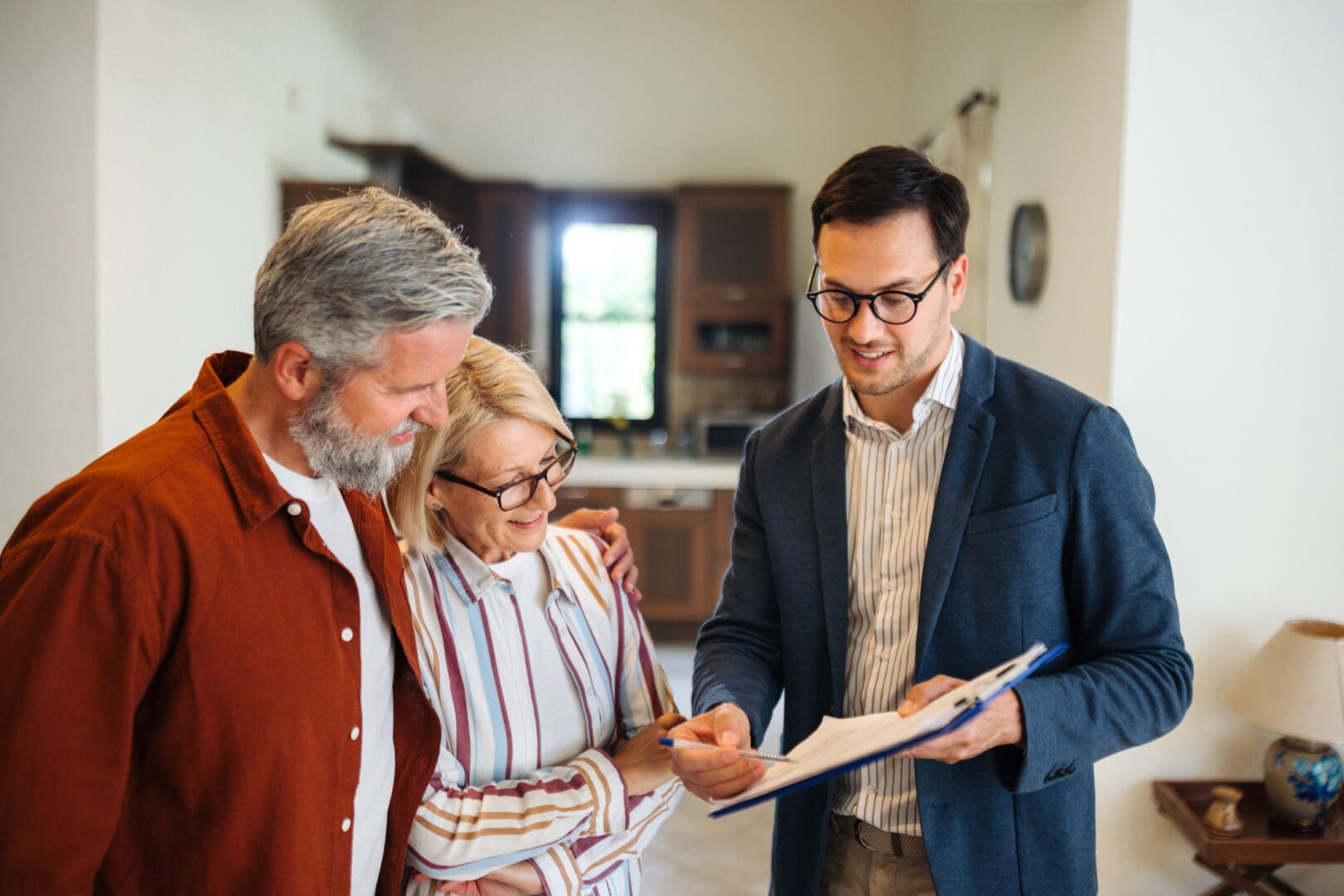Real estate agent showing paperwork to clients