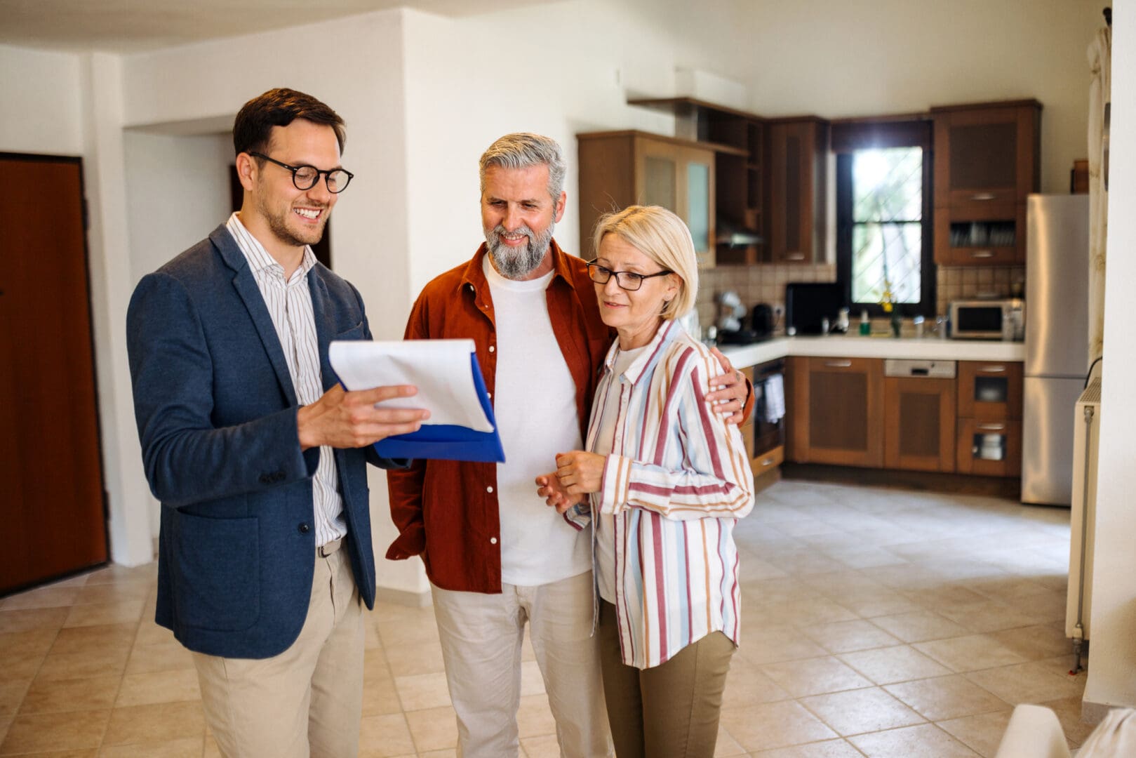 Couple reviewing documents with agent