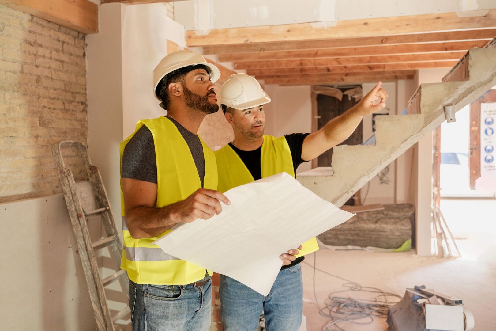 Workers in hard hats planning construction site