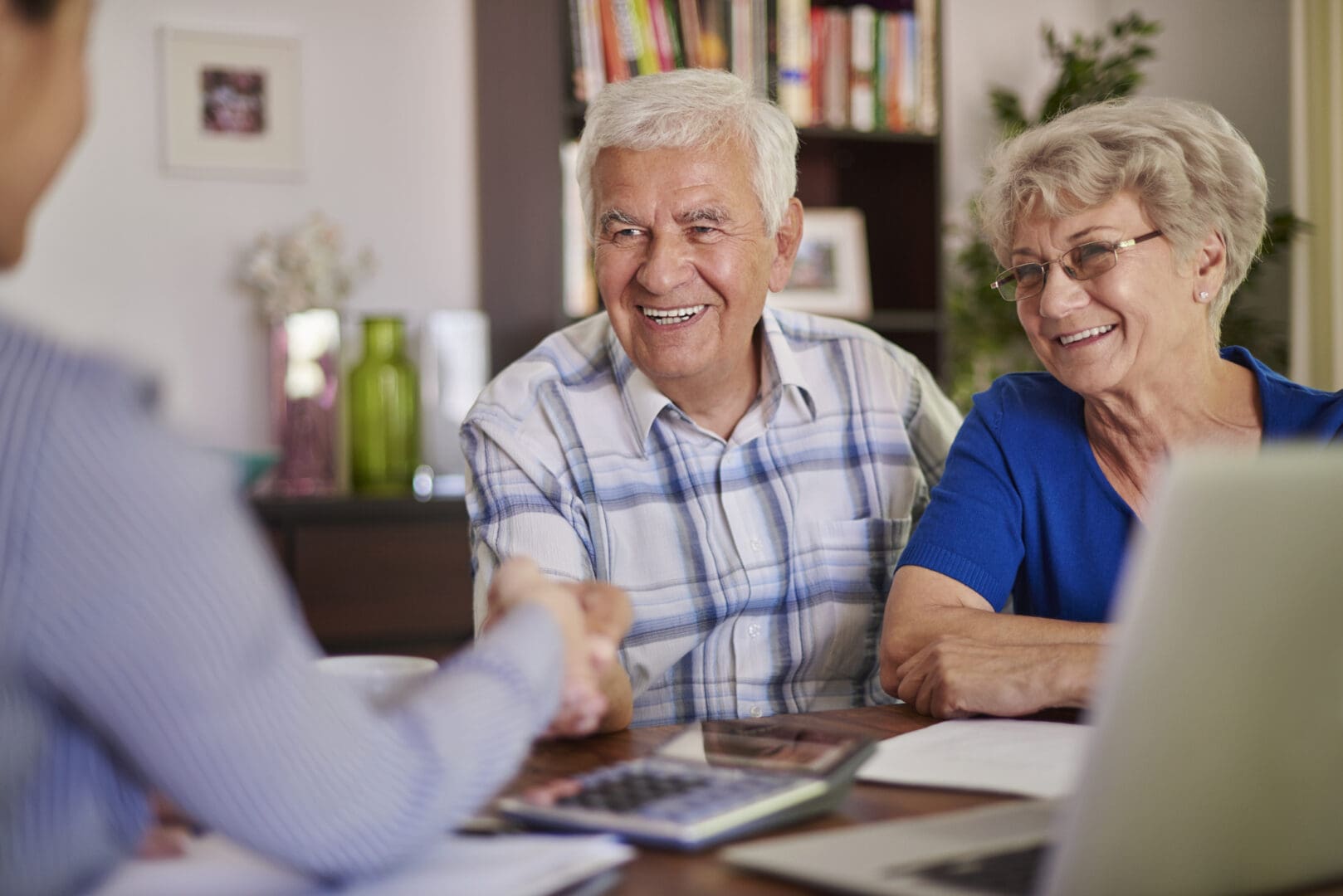 Happy seniors discussing with consultant