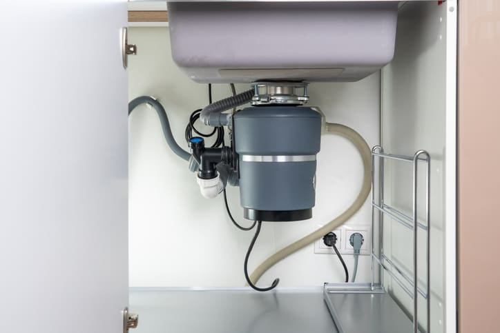 Installed garbage disposal unit under kitchen sink.