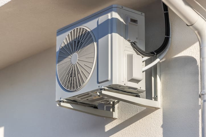 Outdoor air conditioning unit mounted on a wall.
