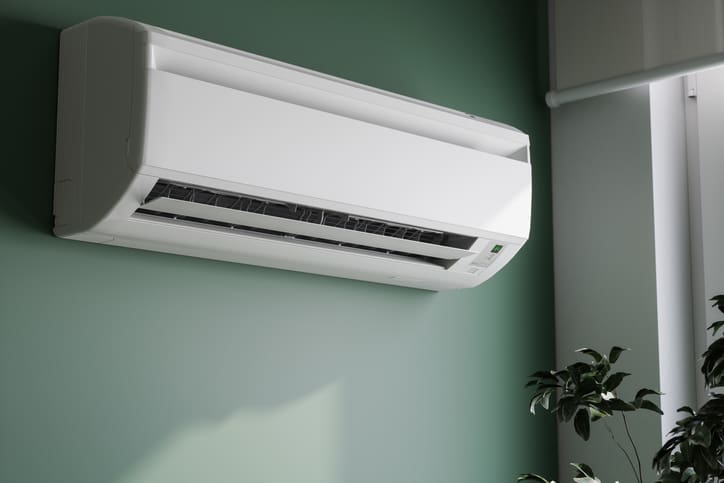 Modern wall-mounted air conditioner installed in a room.