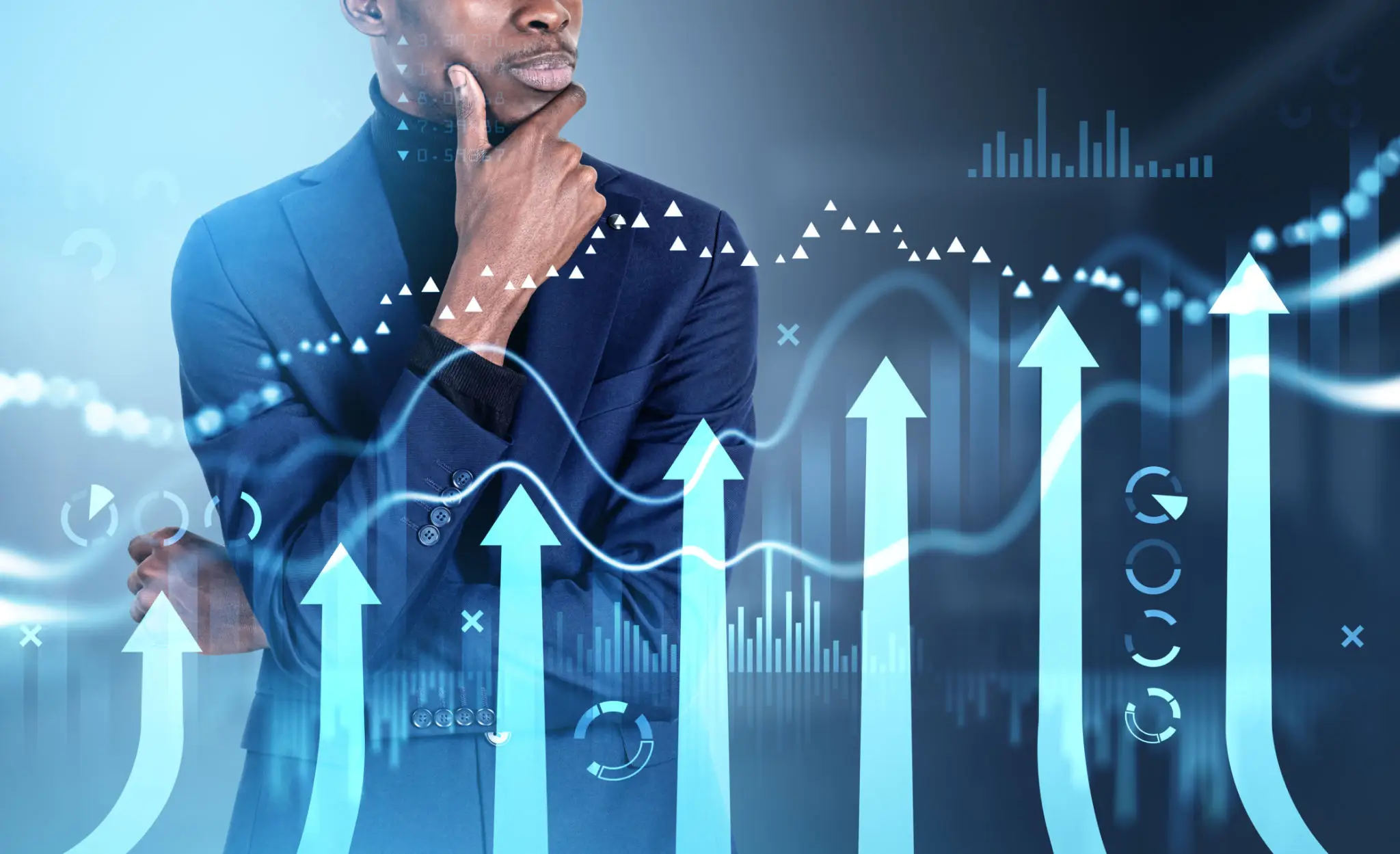 Businessman pondering rising financial charts