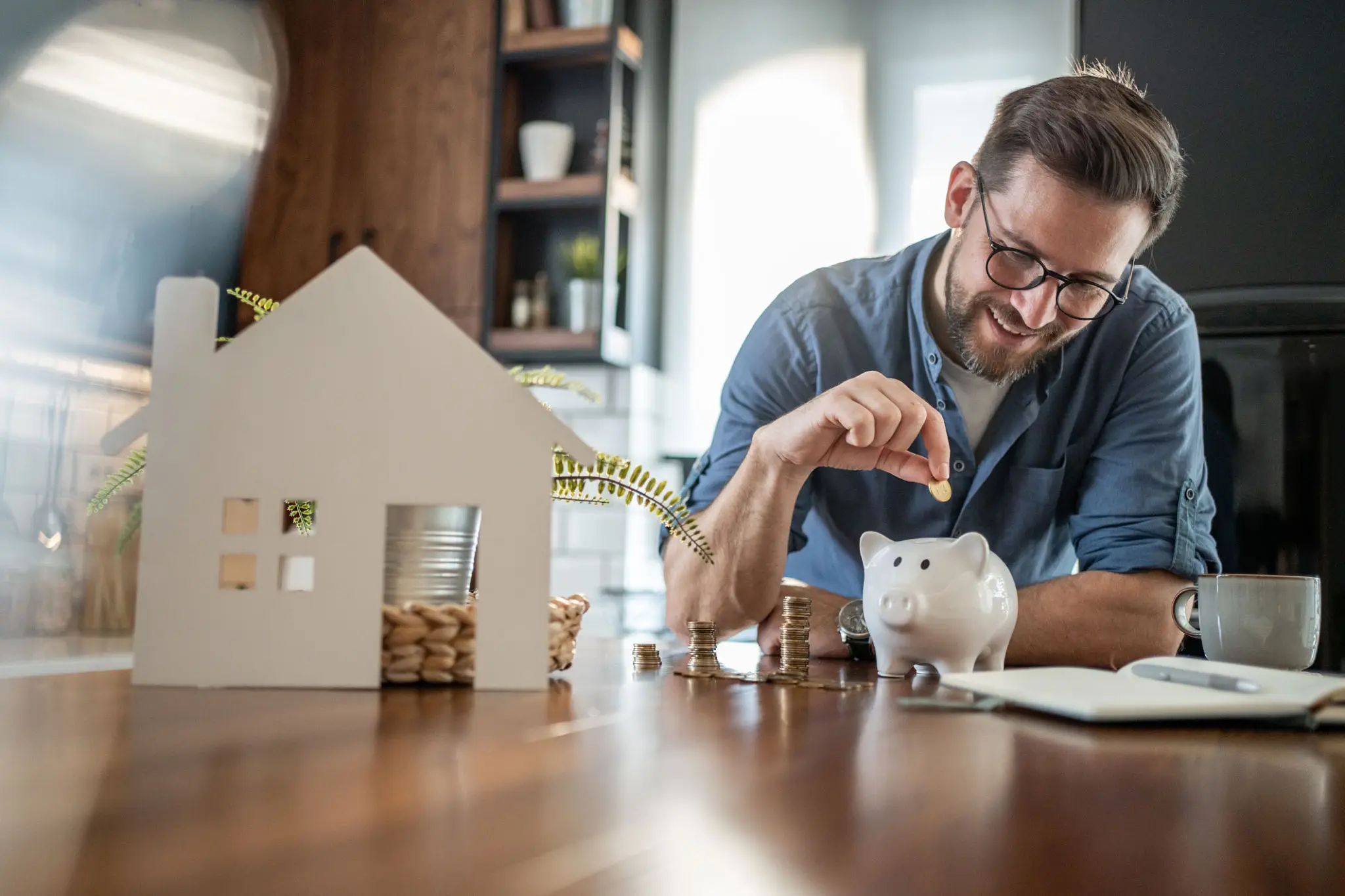 Man putting coin into piggy bank