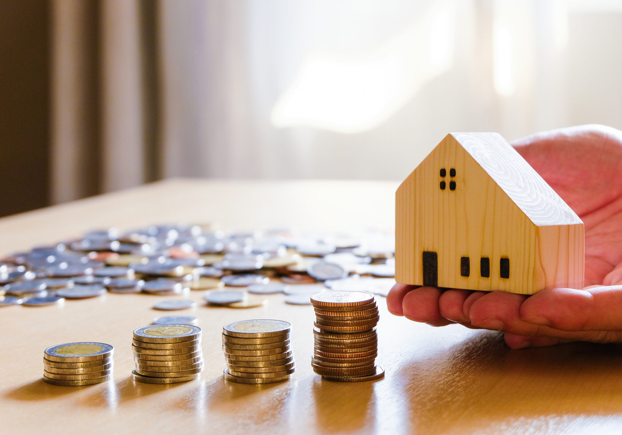 House model with stacked coins