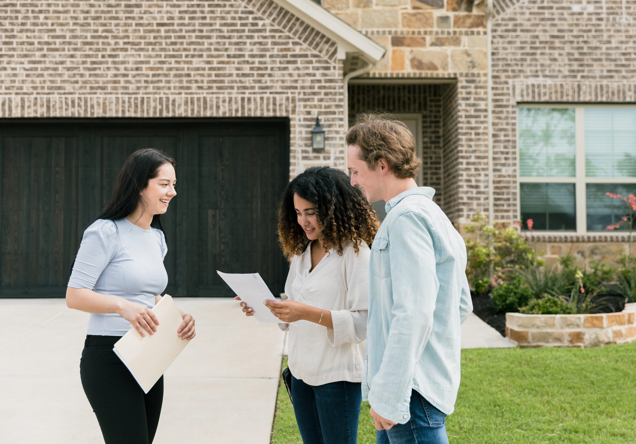 Couple reviewing house documents with agent