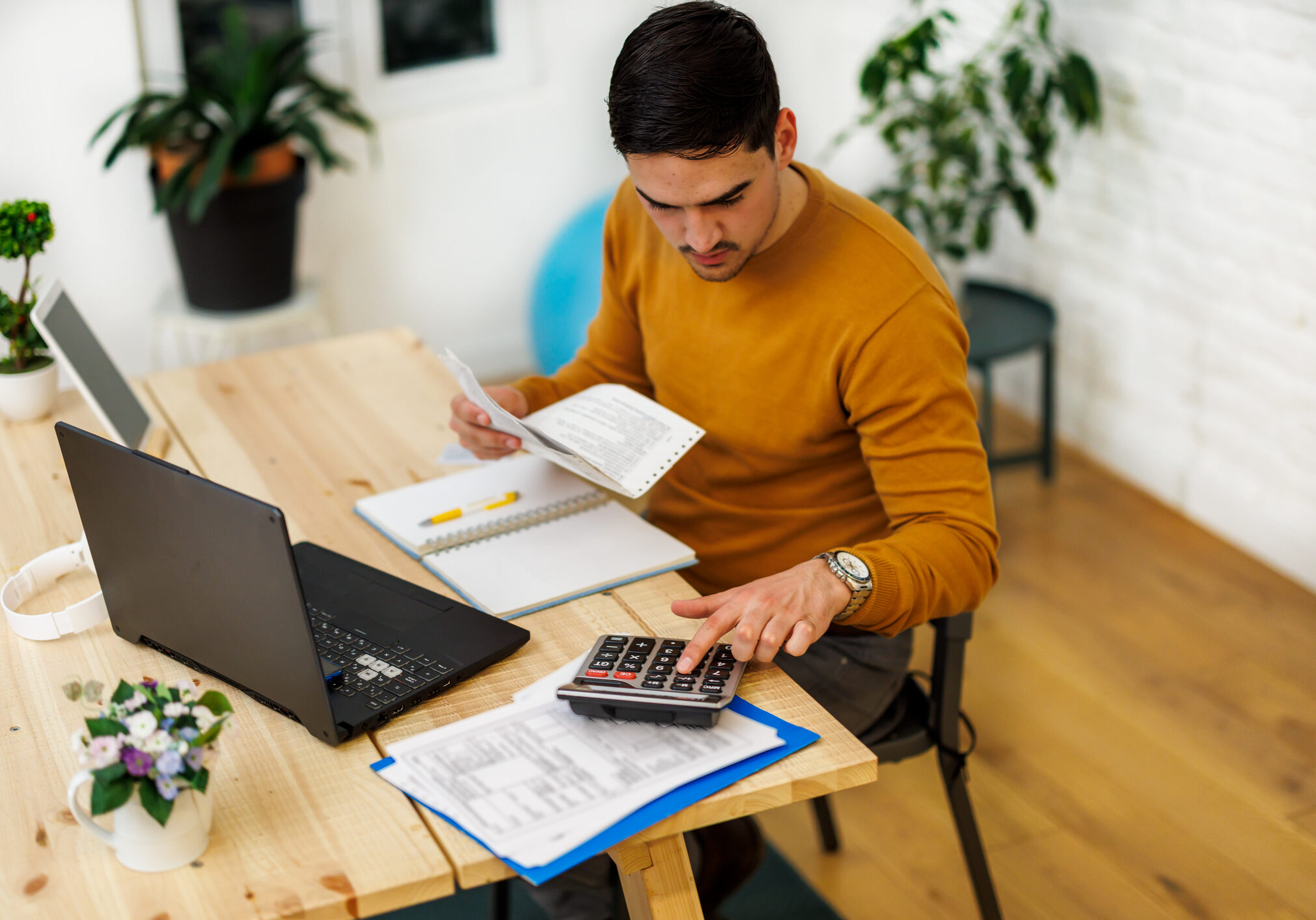 Individual working with documents and calculator