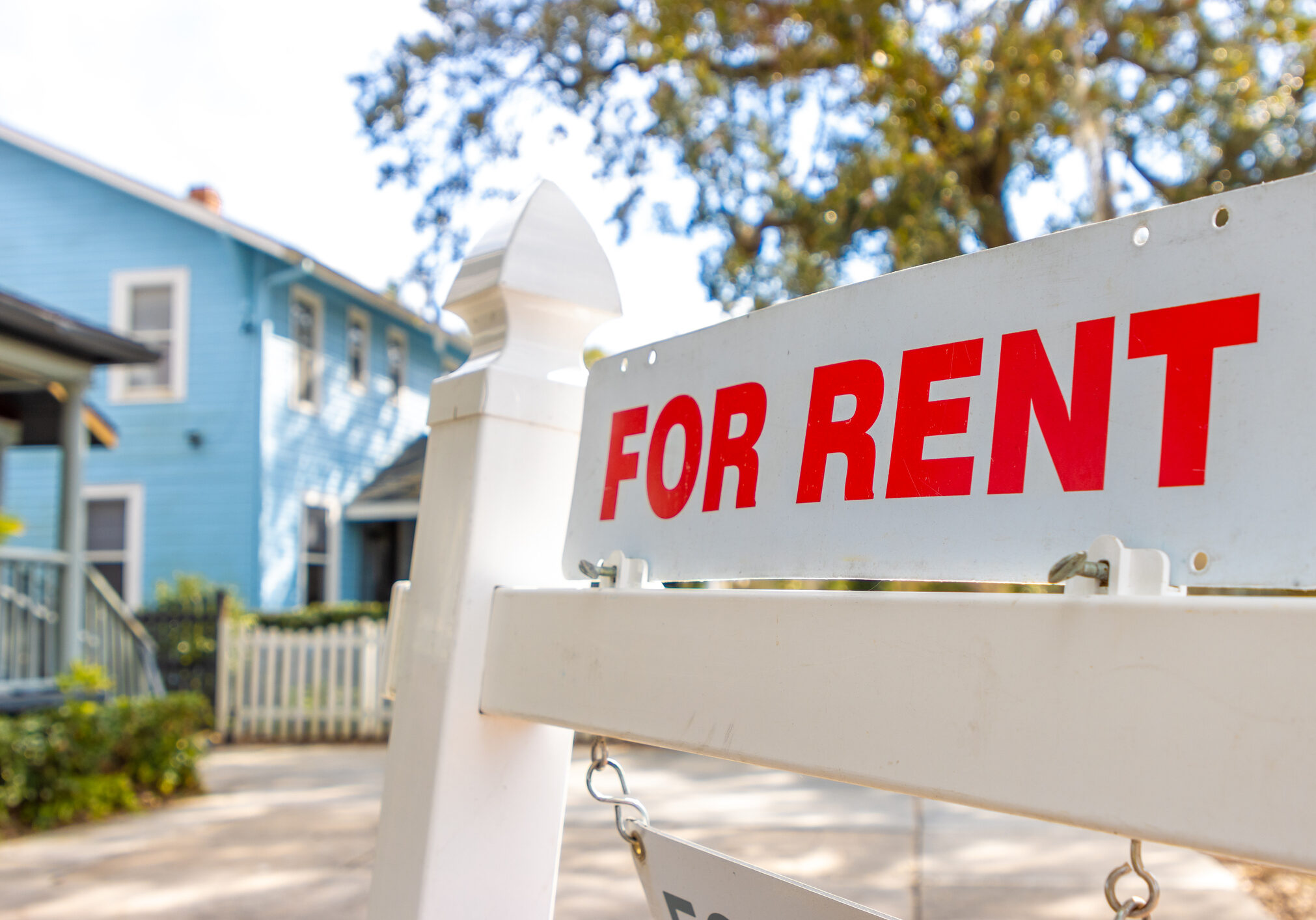 Real estate rental sign and building