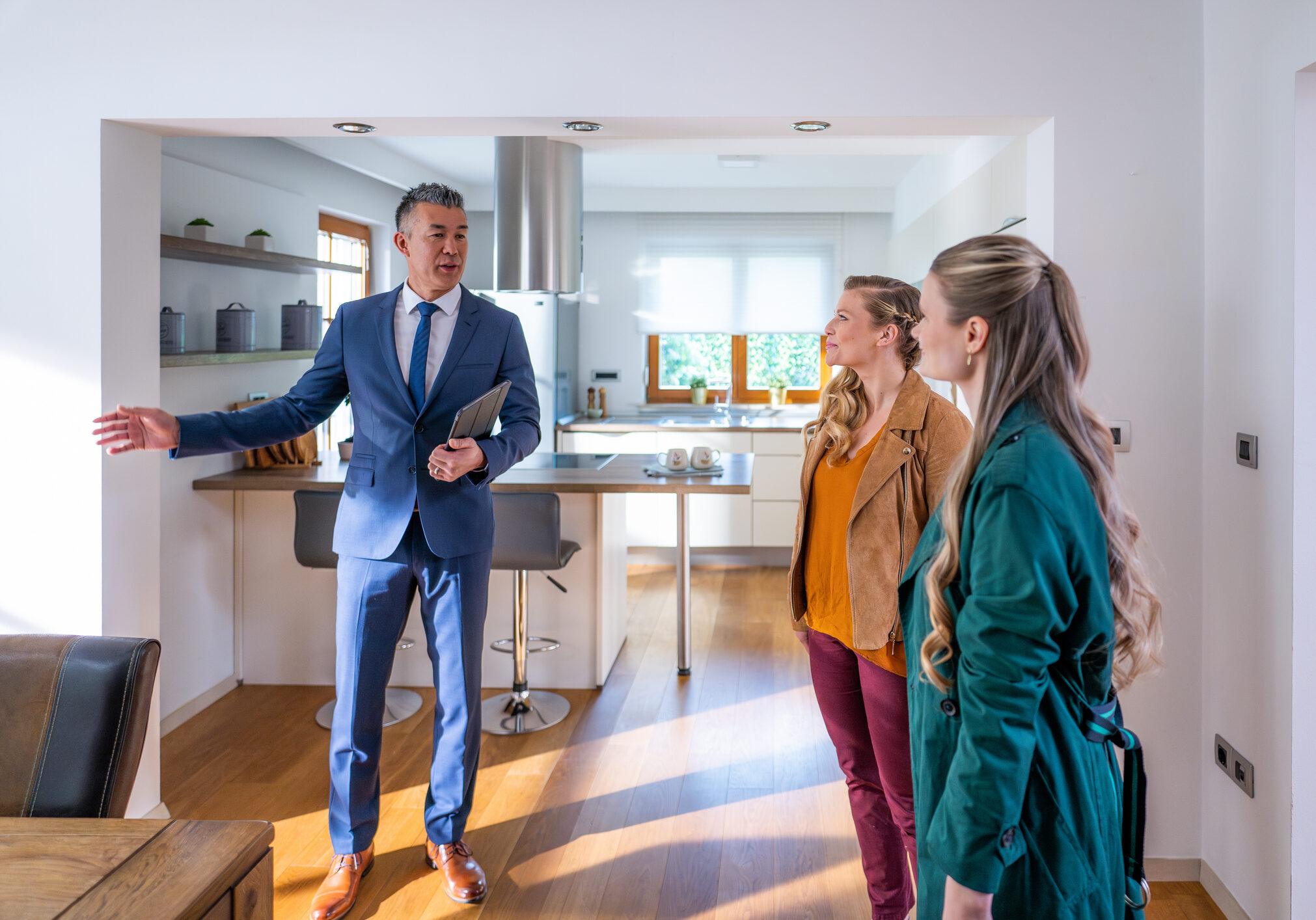 People viewing a bright, spacious kitchen