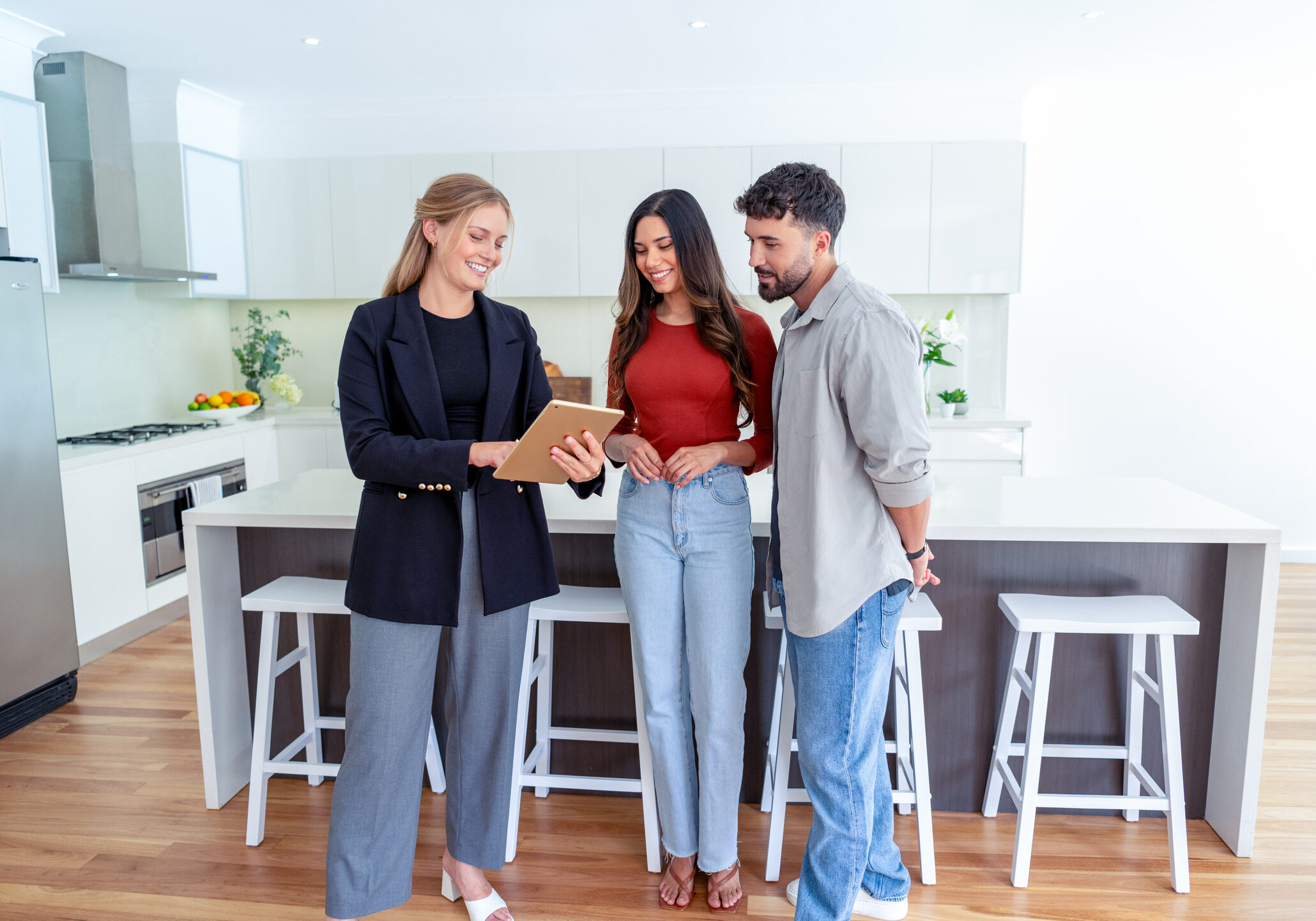 Couple viewing modern kitchen with agent