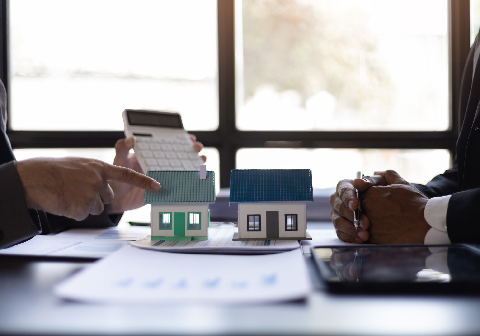 Real estate discussion with house models.