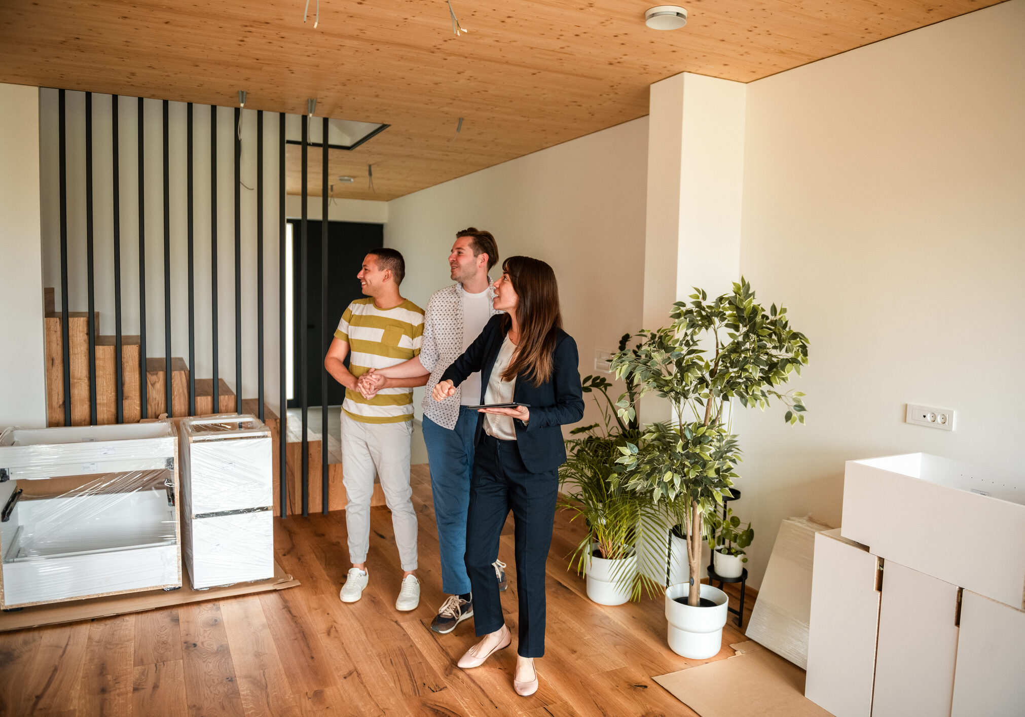 People touring a modern, unfurnished apartment