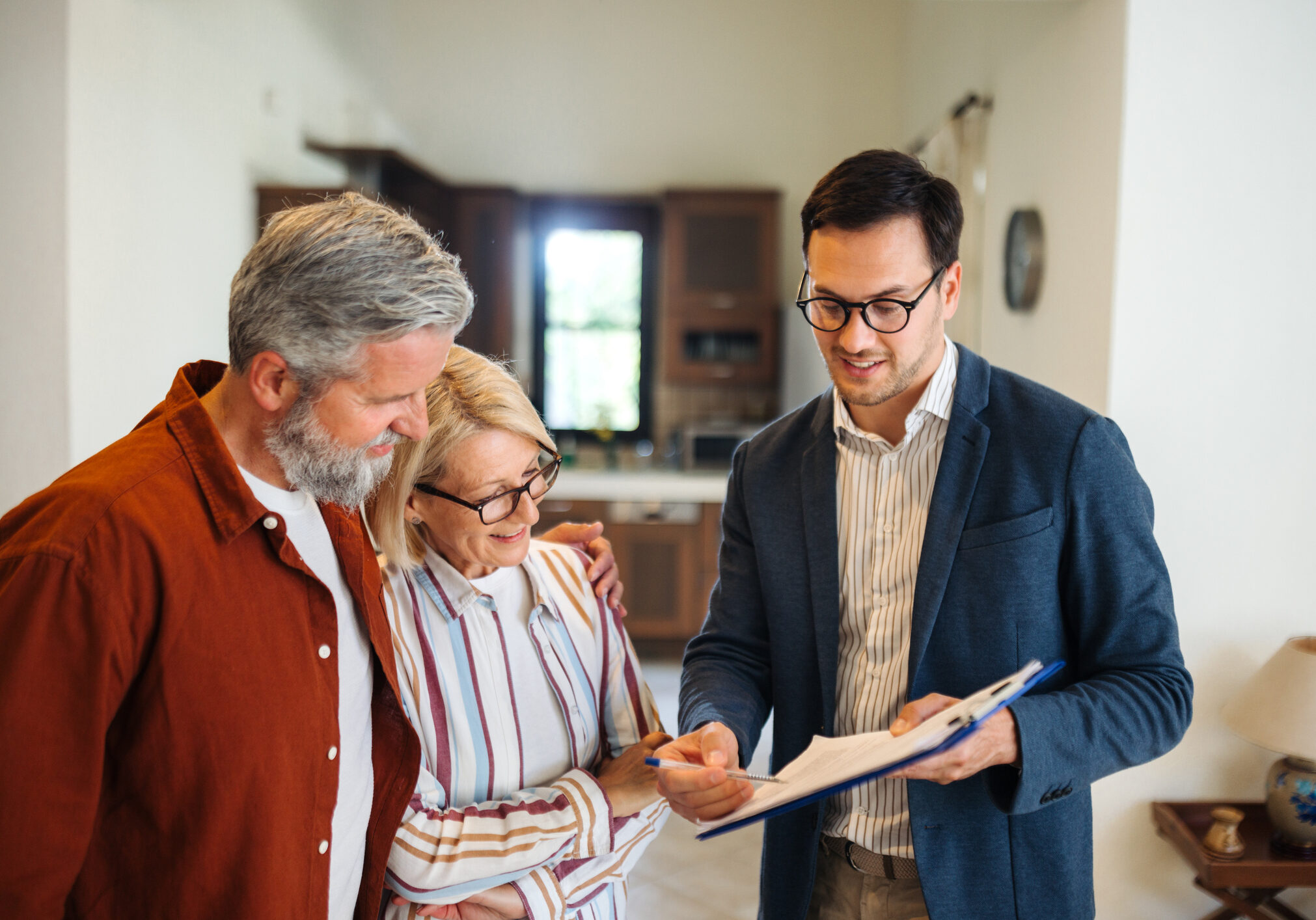Real estate agent showing paperwork to clients