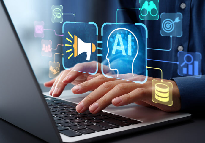 Hands typing on a laptop with AI and technology icons floating above.