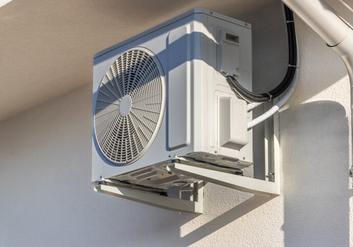 Outdoor air conditioning unit mounted on a wall.