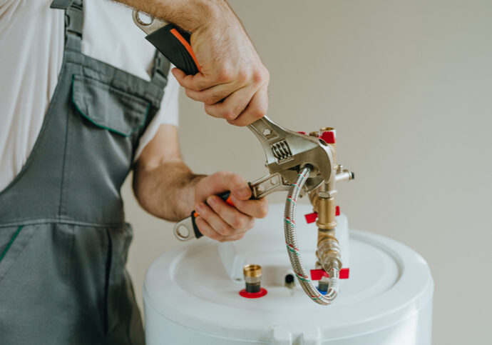 Technician assembling a mechanical component with tools.
