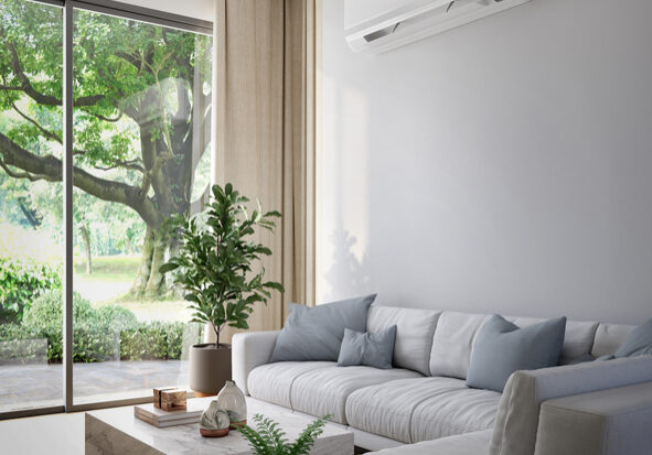 Modern living room with gray sofa and large window.