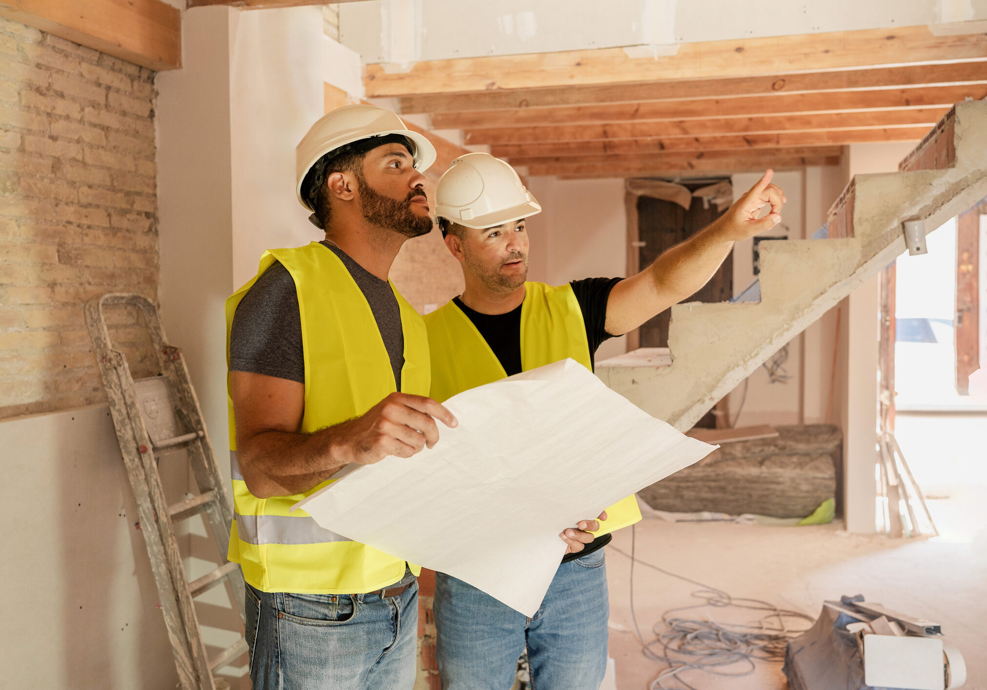 Workers in hard hats planning construction site