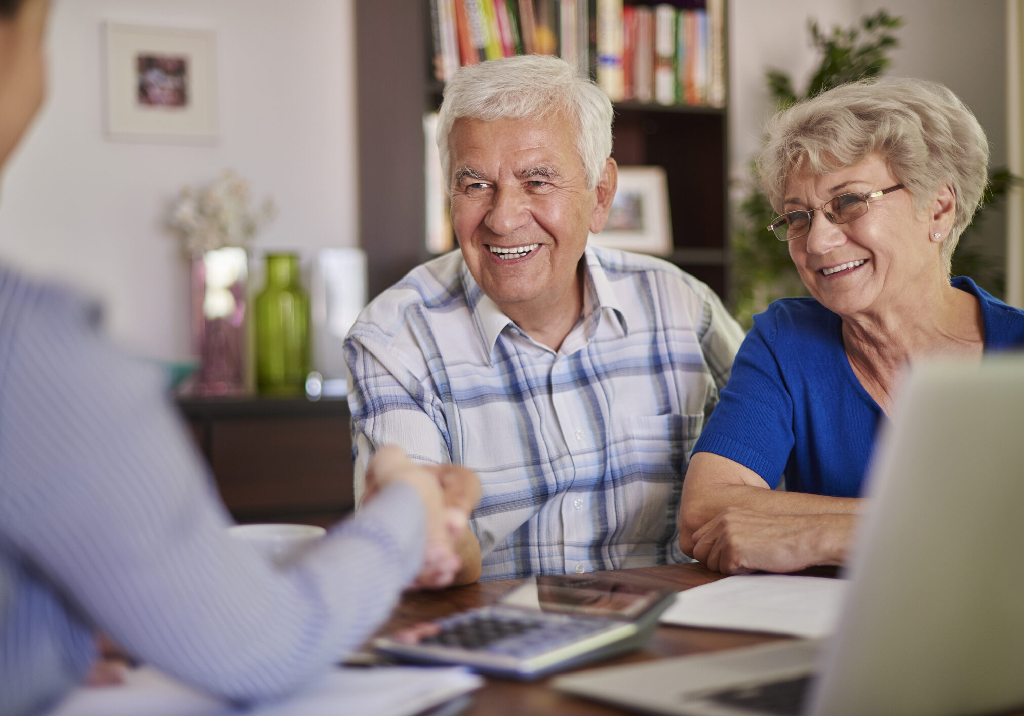 Happy seniors discussing with consultant