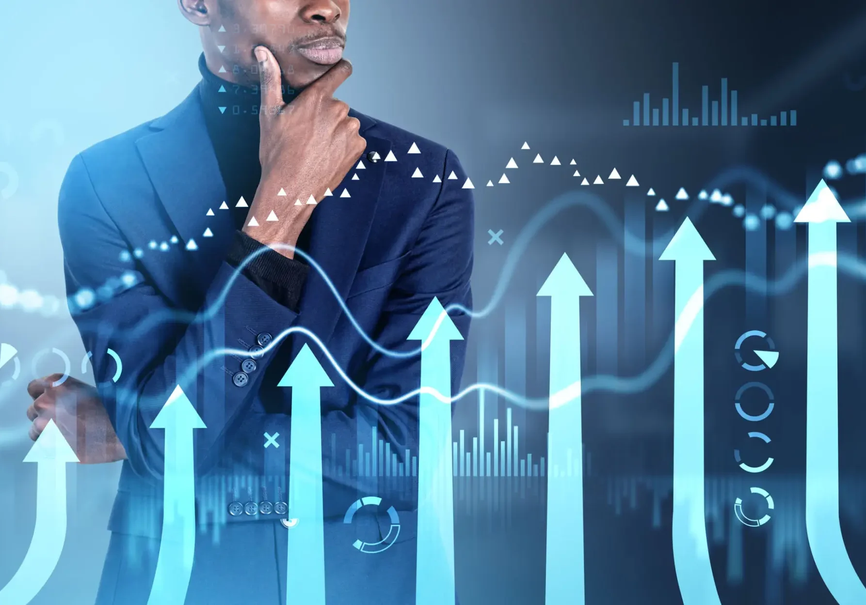 Businessman pondering rising financial charts
