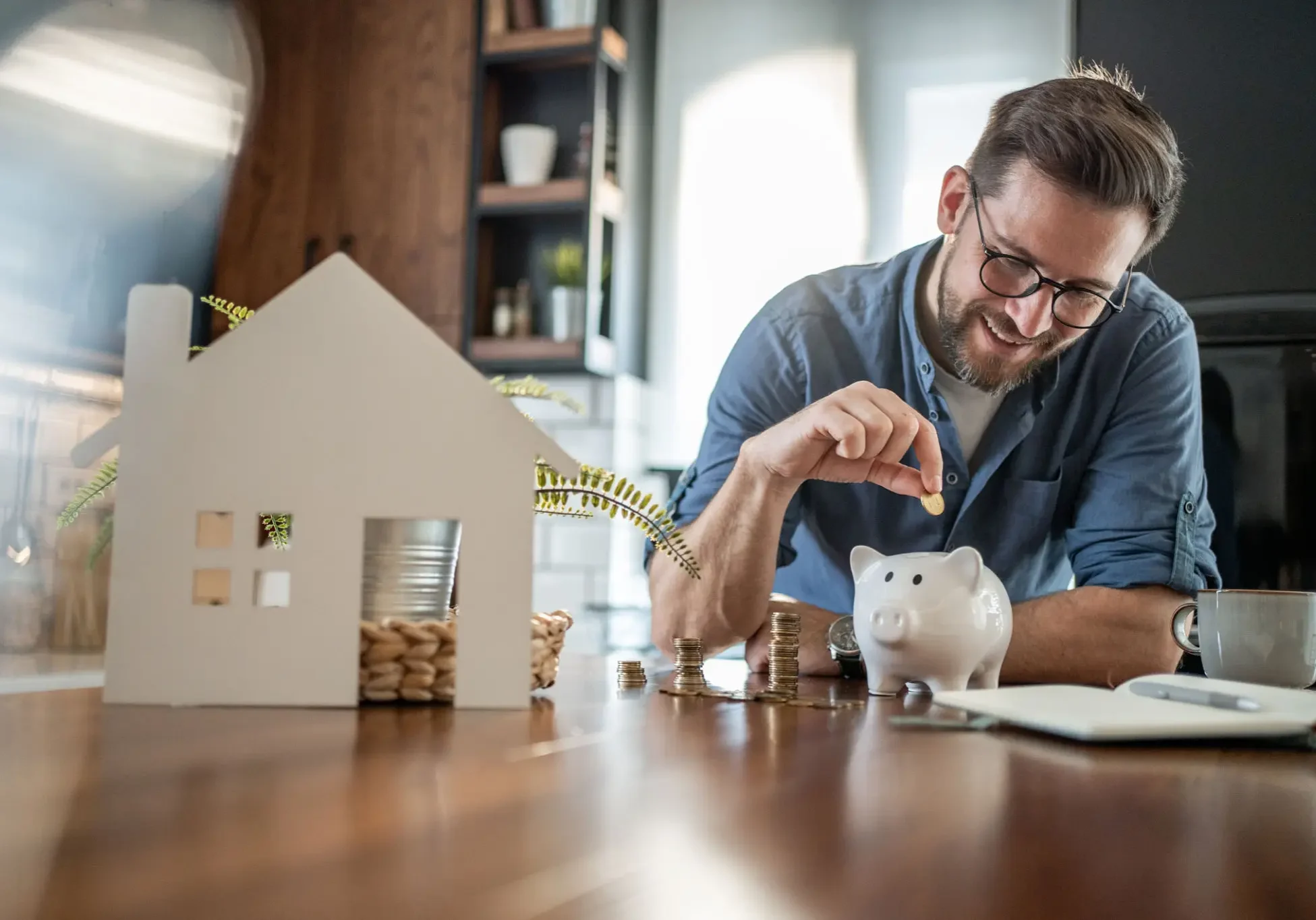 Man putting coin into piggy bank
