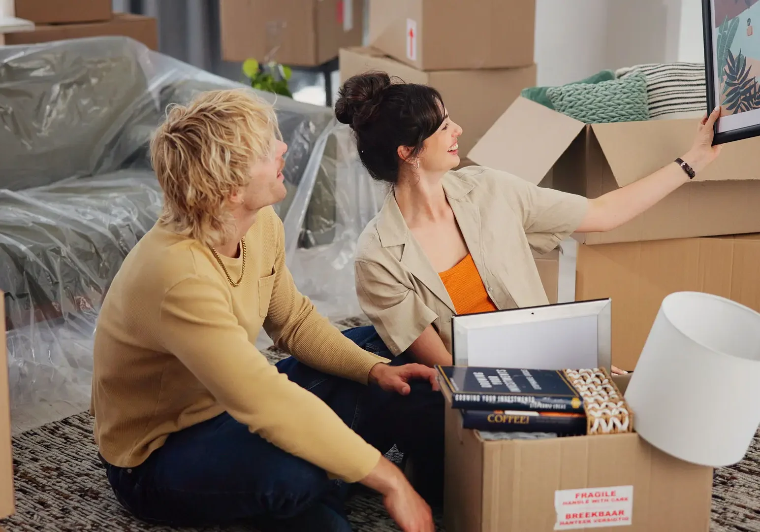 Couple unpacking boxes in new home