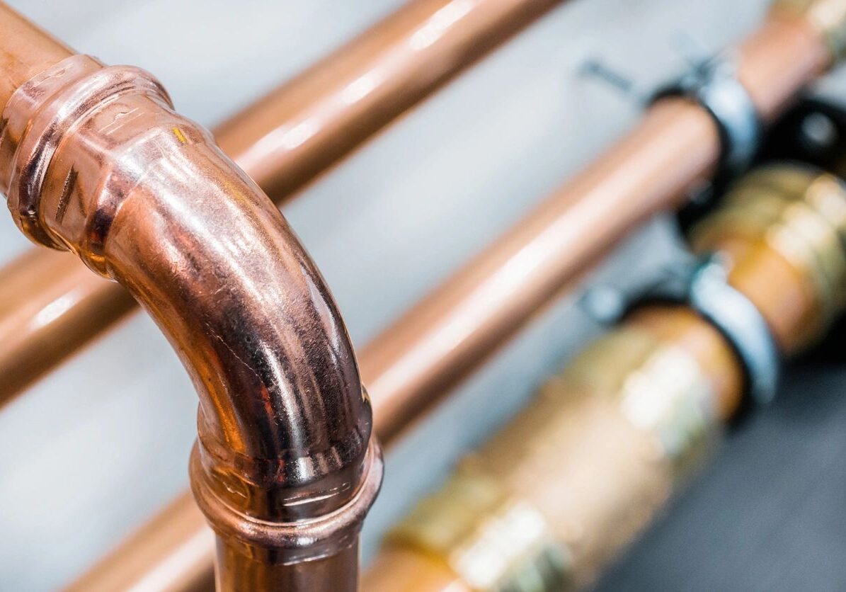 Close-up of shiny copper plumbing pipes.