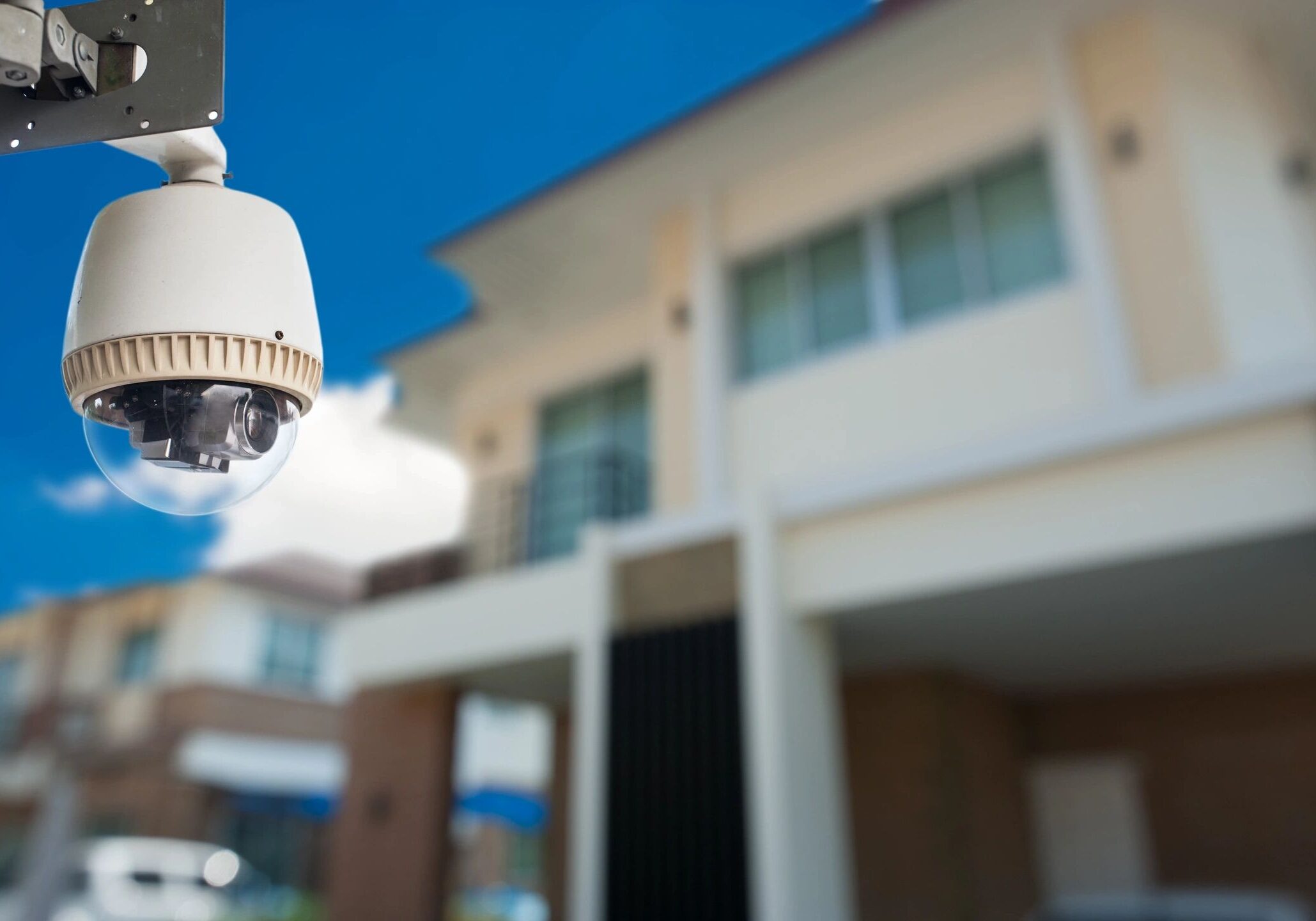 Security camera monitoring outside a building.
