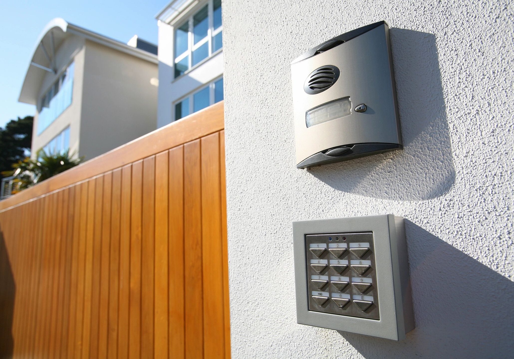 Modern intercom system and keypad at home entrance.