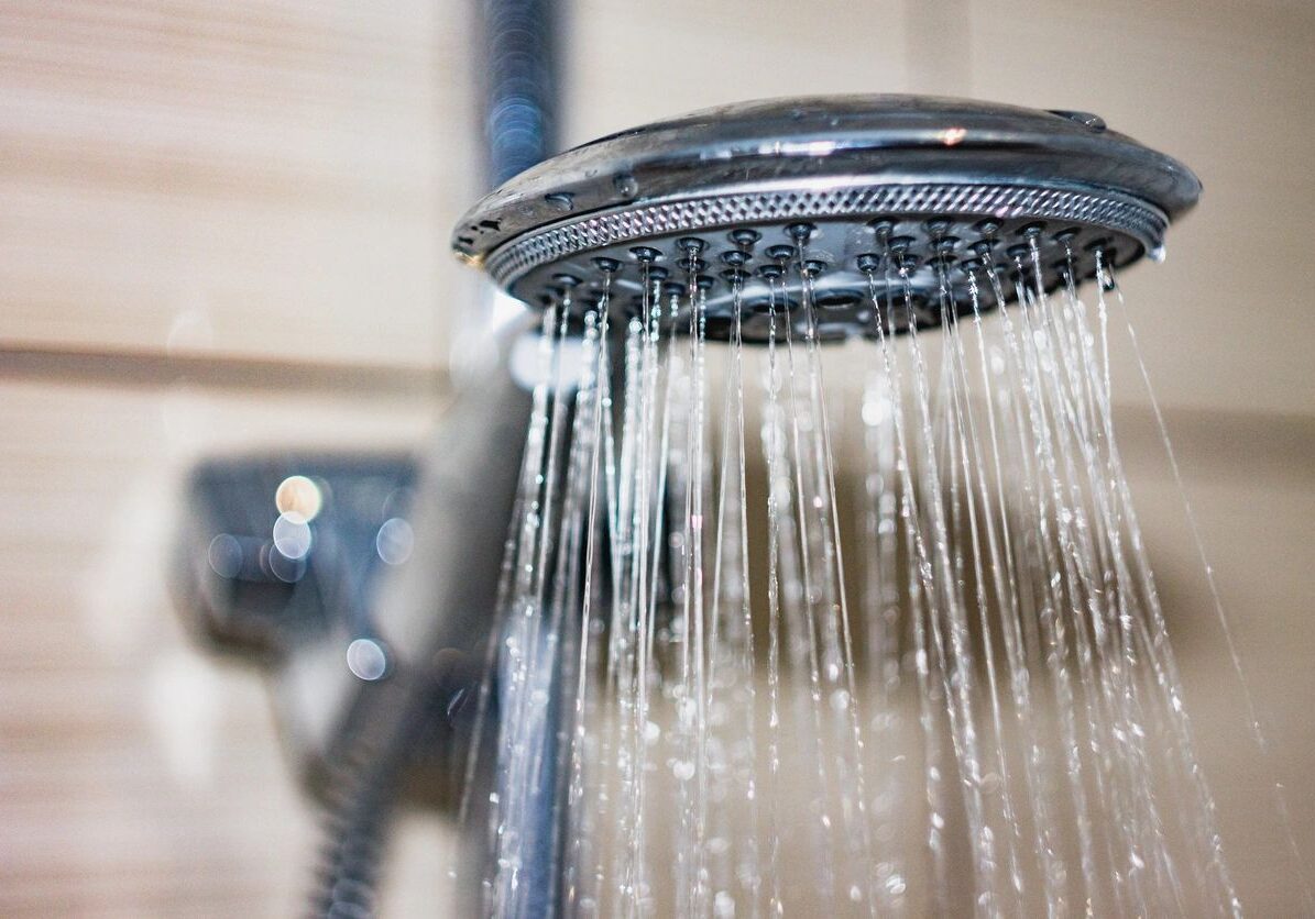 Close-up of water streaming from a showerhead.