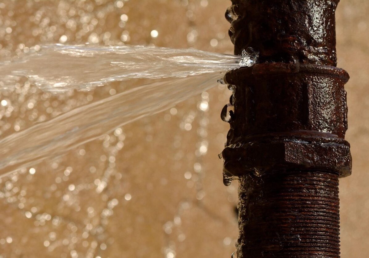 Water leaking from a rusty pipe.