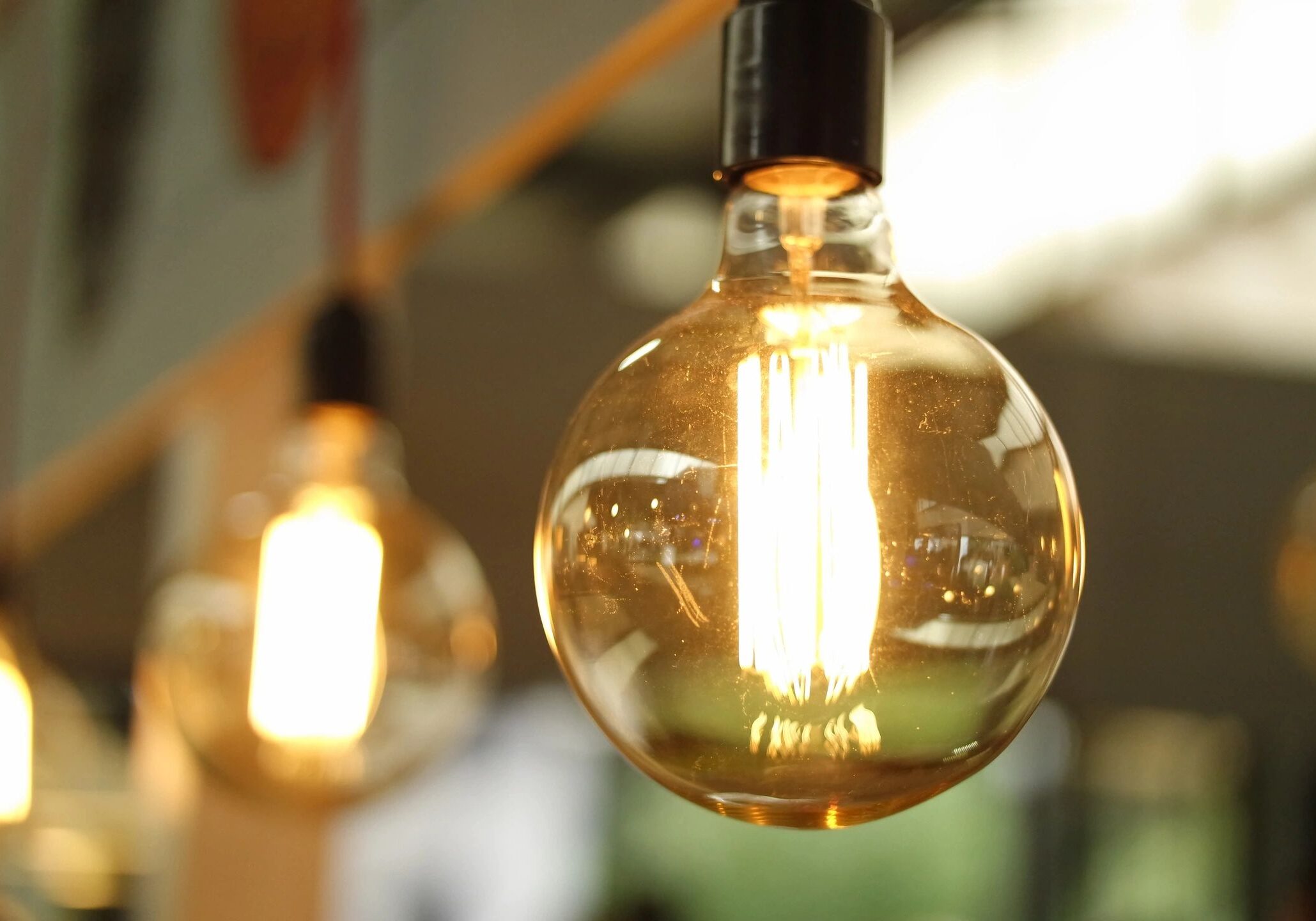 Close-up of a glowing vintage filament light bulb.